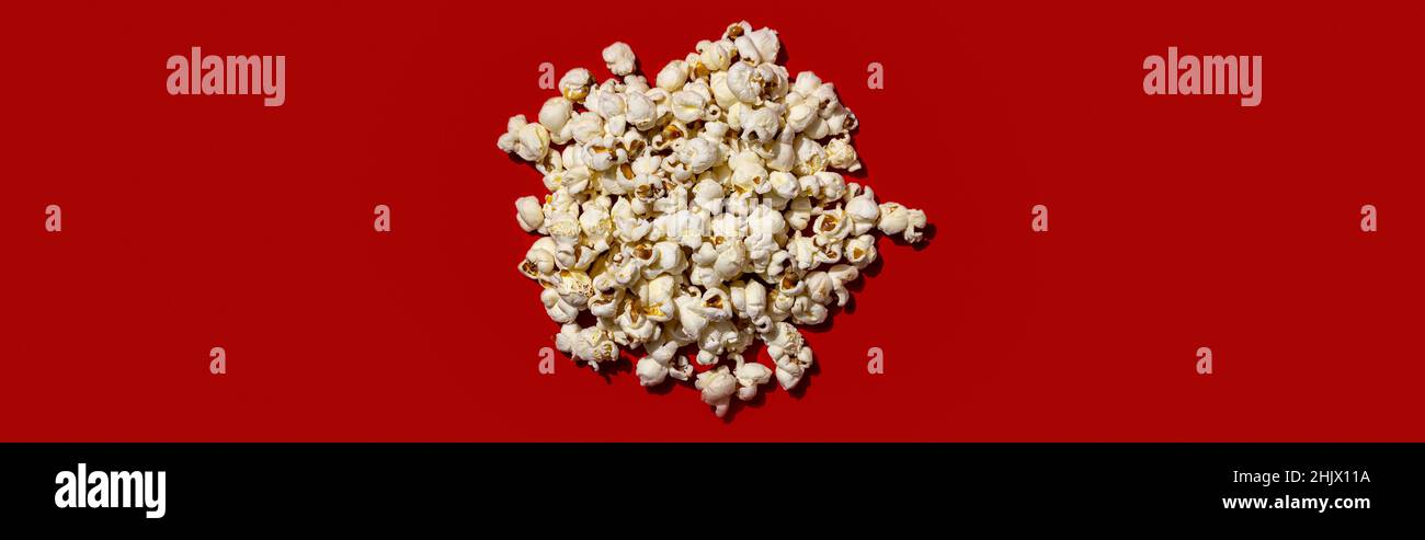 Popcorn heap on red background. Stock Photo