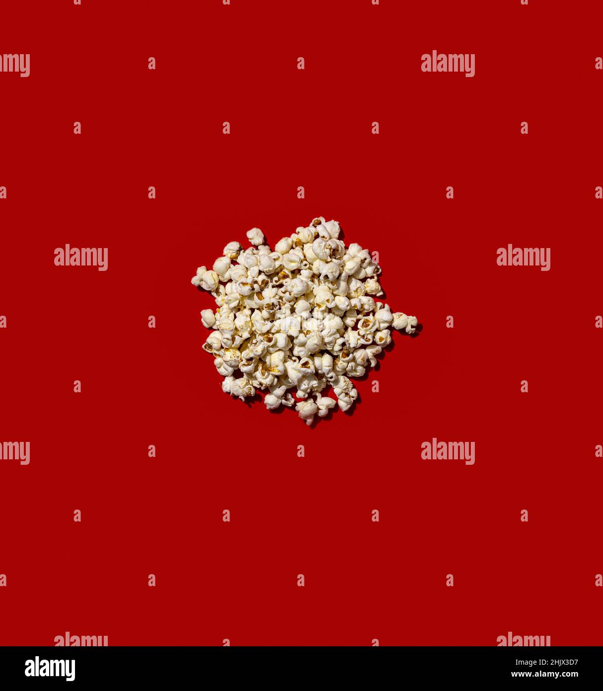 Popcorn heap on red background. Stock Photo