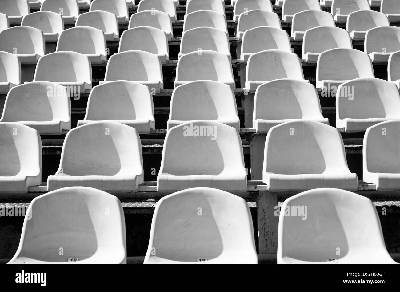 empty yellow seats on outdoor sport stadium arena for football fans