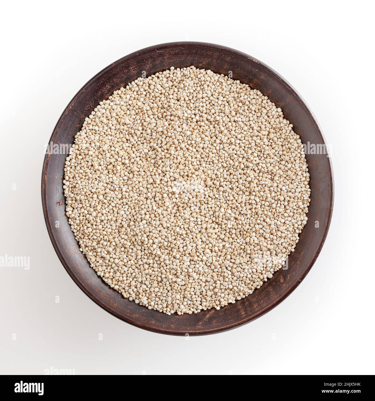 Dried white quinoa seeds in ceramic bowl isolated on white background with clipping path Stock Photo