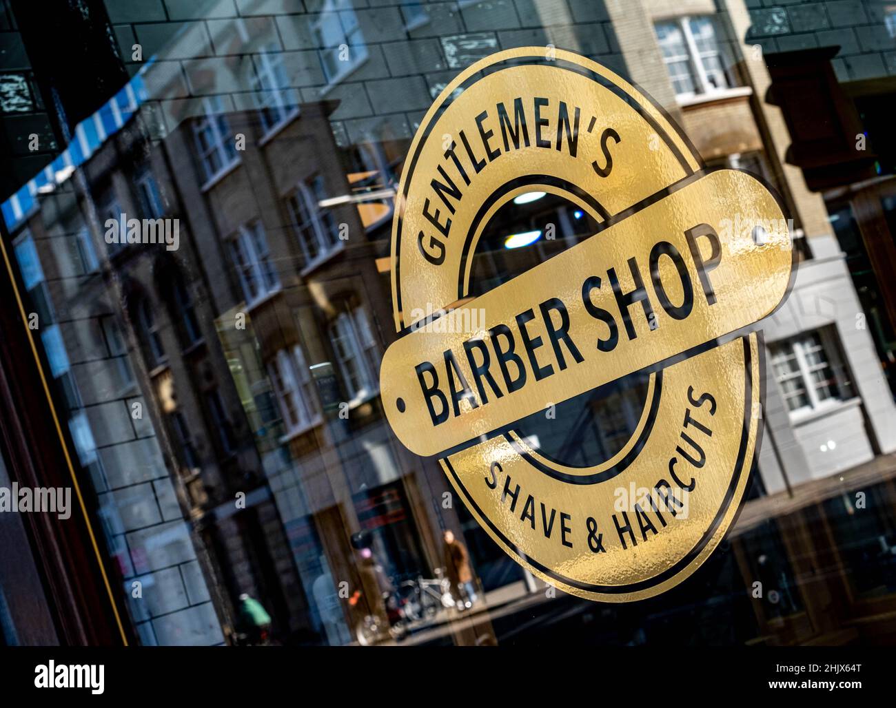 London England UK, 29 January 2022, Gentlemen’s Barber Shop Window Reflecting The Building Opposite Stock Photo