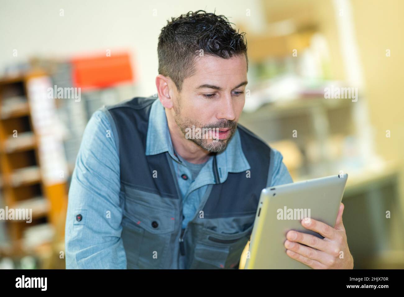 worker checking package by using tablet in warehouse Stock Photo