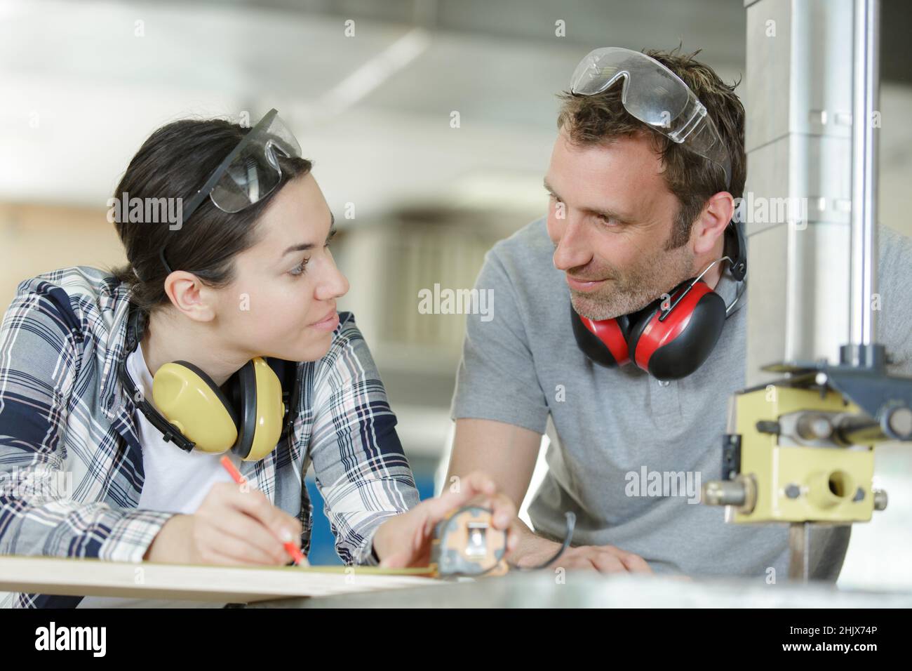 woman watching her manager doing diy carpentry Stock Photo