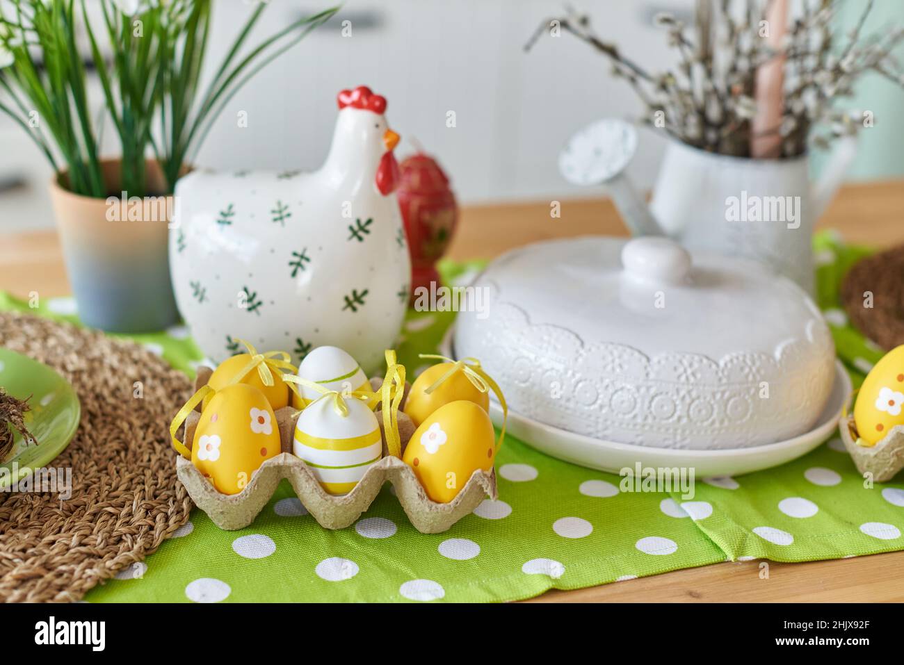 Easter table decoration in the kitchen with colored eggs. Stock Photo