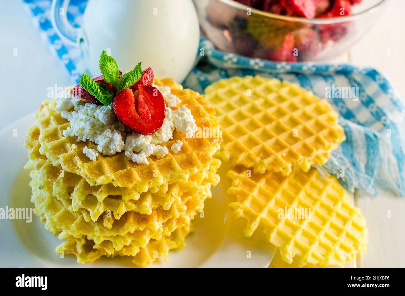 milk and ripple waffles with cottage cheese and strawberries Stock Photo