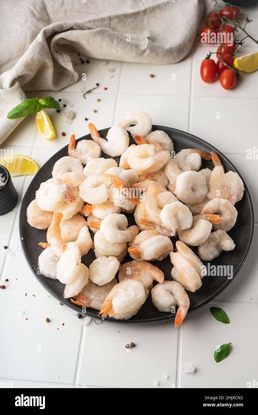 Thawed peeled shrimp, seafood, delicacy. on a white background, in a ...