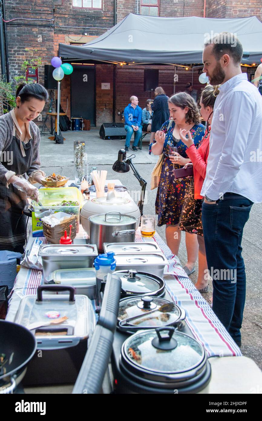 Sheffield,  UK - June 22: Members of the Sheffield Creative Guild queue for Korean Soul street food at the 2nd Anniversary party at Yellow Arch Studio Stock Photo