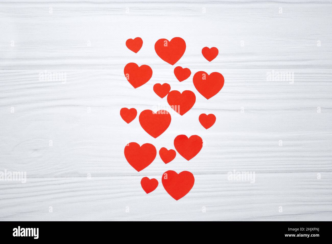 Red paper hearts hanging on white wooden background. Valentinas day ...