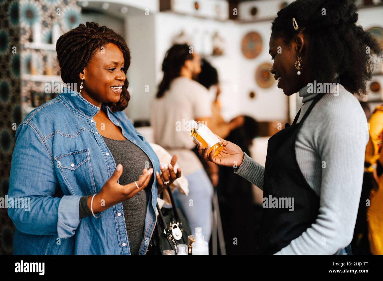 Female coworkers discussing on beauty product in hair salon Stock Photo - Alamy Female coworkers discussing on beauty product in hair salon Stock Photo - Alamy