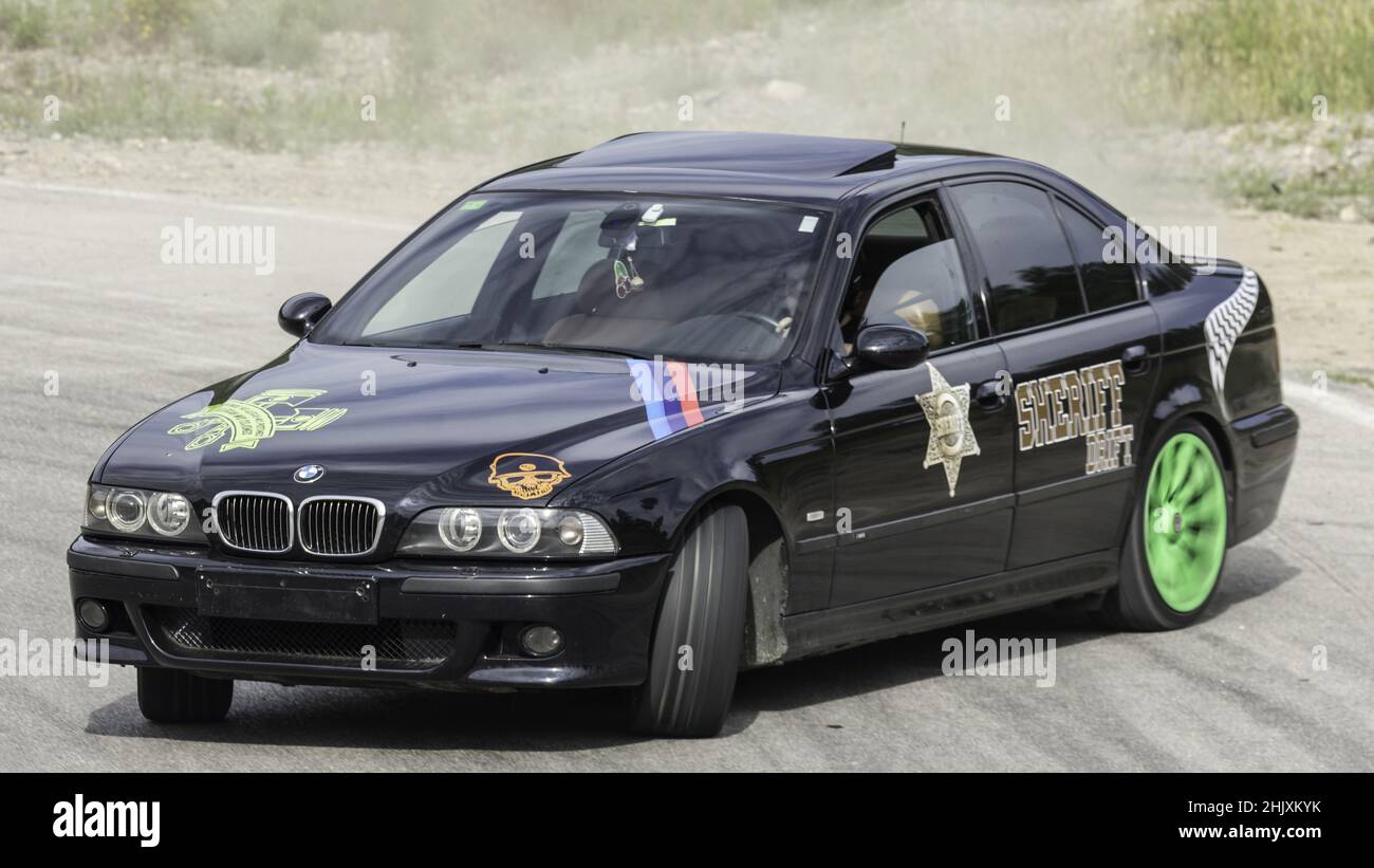 Black BMW E39 drifting on the circuit on the highway on a sunny day ...