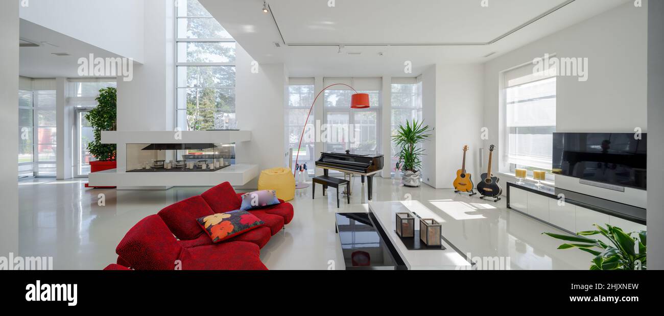 Modern interior of luxury private house. Spacious living room with red ...
