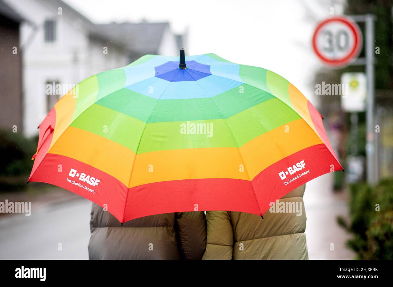 Oldenburg, Germany. 01st Feb, 2022. Two young women walk along a sidewalk in rainy weather with