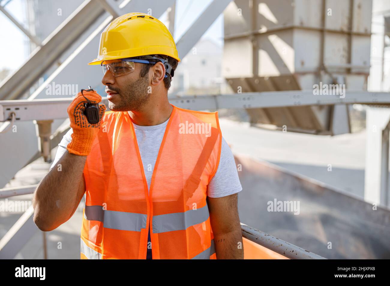Young building industry worker working hard outdoors Stock Photo