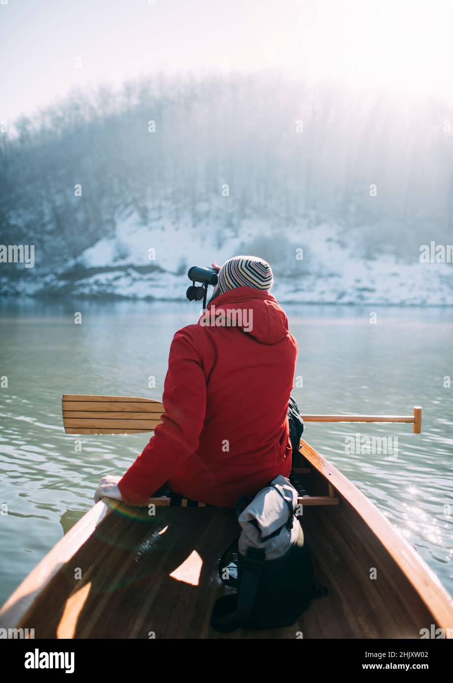 Rear view of man watching birds from the canoe Stock Photo - Alamy