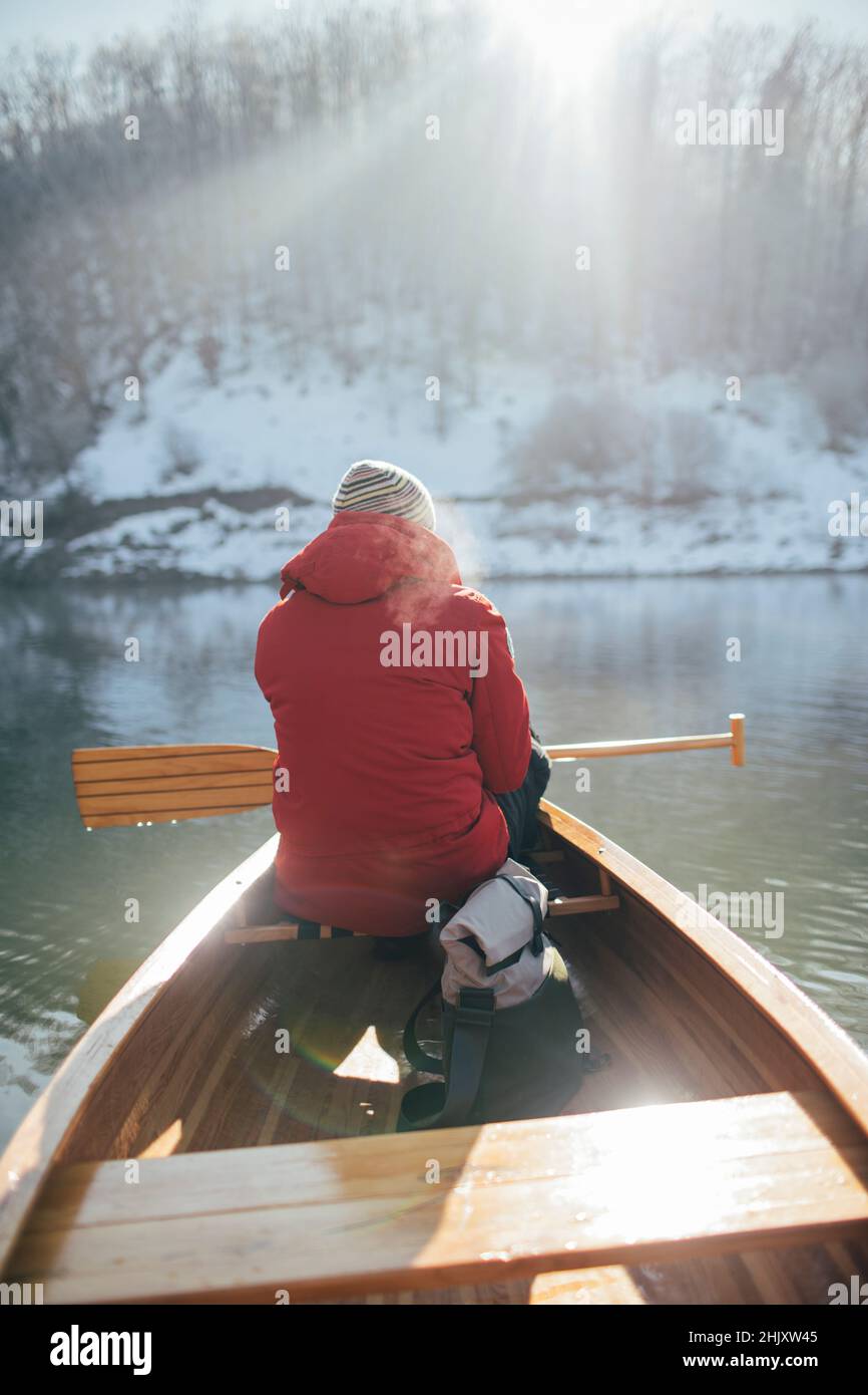 Winter canoe ride. Rear view of man paddling on winter canoe ride Stock ...
