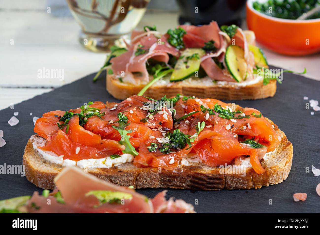 Grilled bruschetta with salmon fillet and jamon. Delicious Italian ...