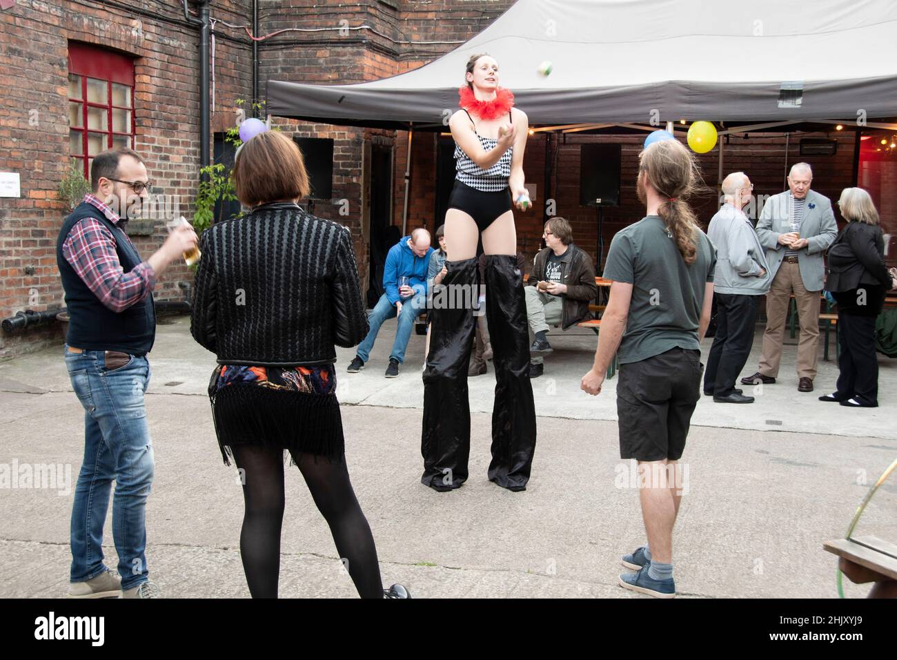 Sheffield,  UK - June 22: Sheffield Creative Guild members practice circus skills during diner at the 2nd Anniversary birthday party, Yellow Arch Stud Stock Photo