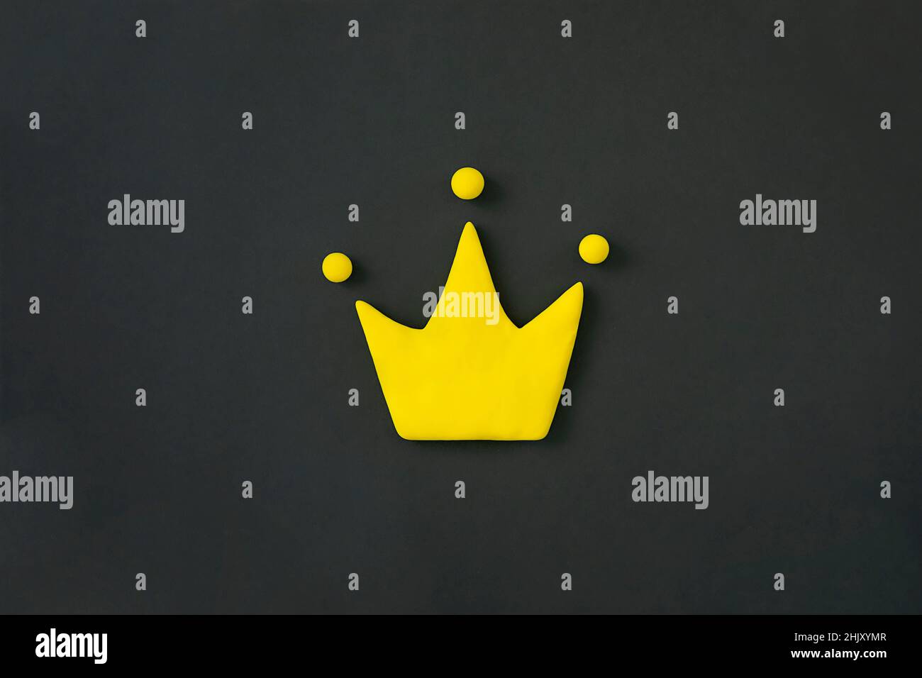 Simple 3d yellow crown symbol on black background. Concept of win and success, top rank quality status. Stock Photo