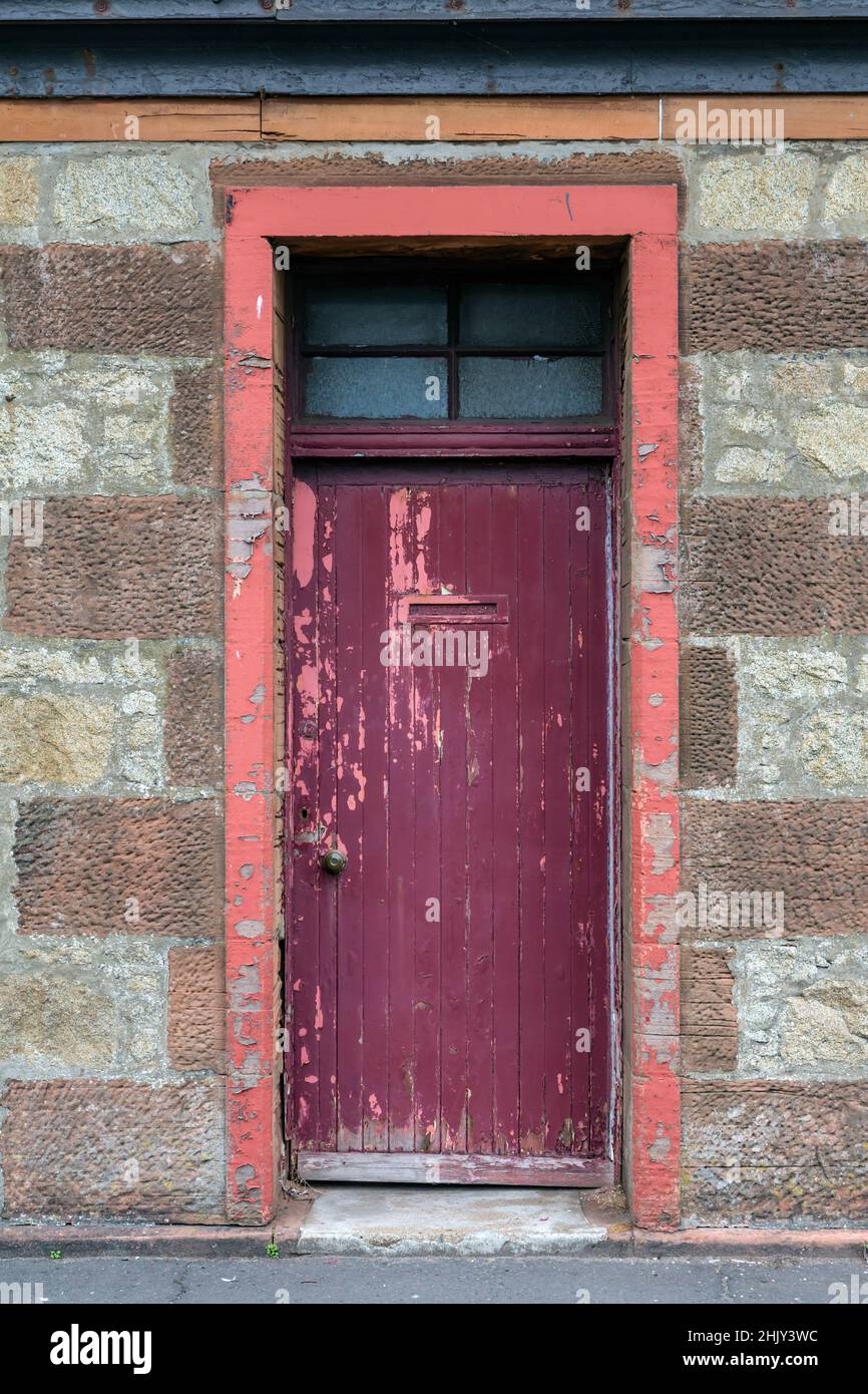 An old worn red exterior house door, UK Stock Photo