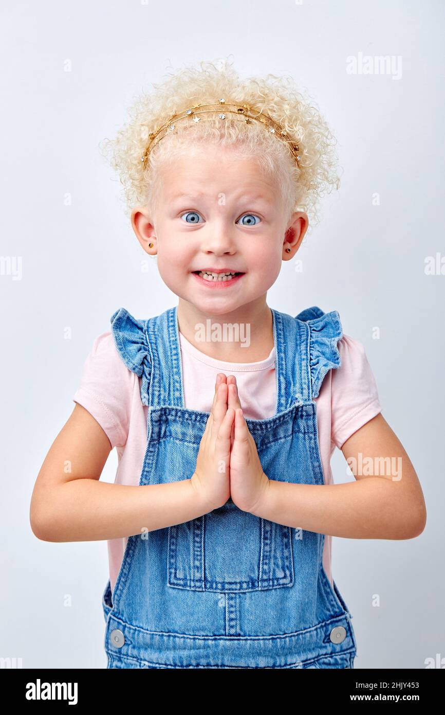 Surprise, excitement and fascination concept. Funny big blue eyed girl smiling, shocked with astonishing unexpected news, having amazed look, showing Stock Photo