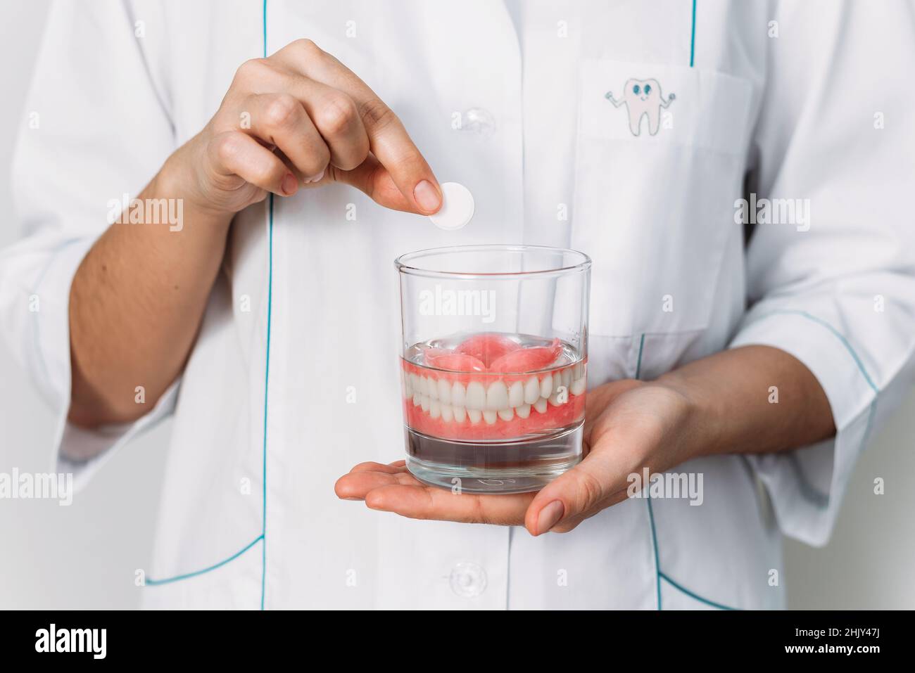An orthopedic dentist shows how to take care of dentures, closeup