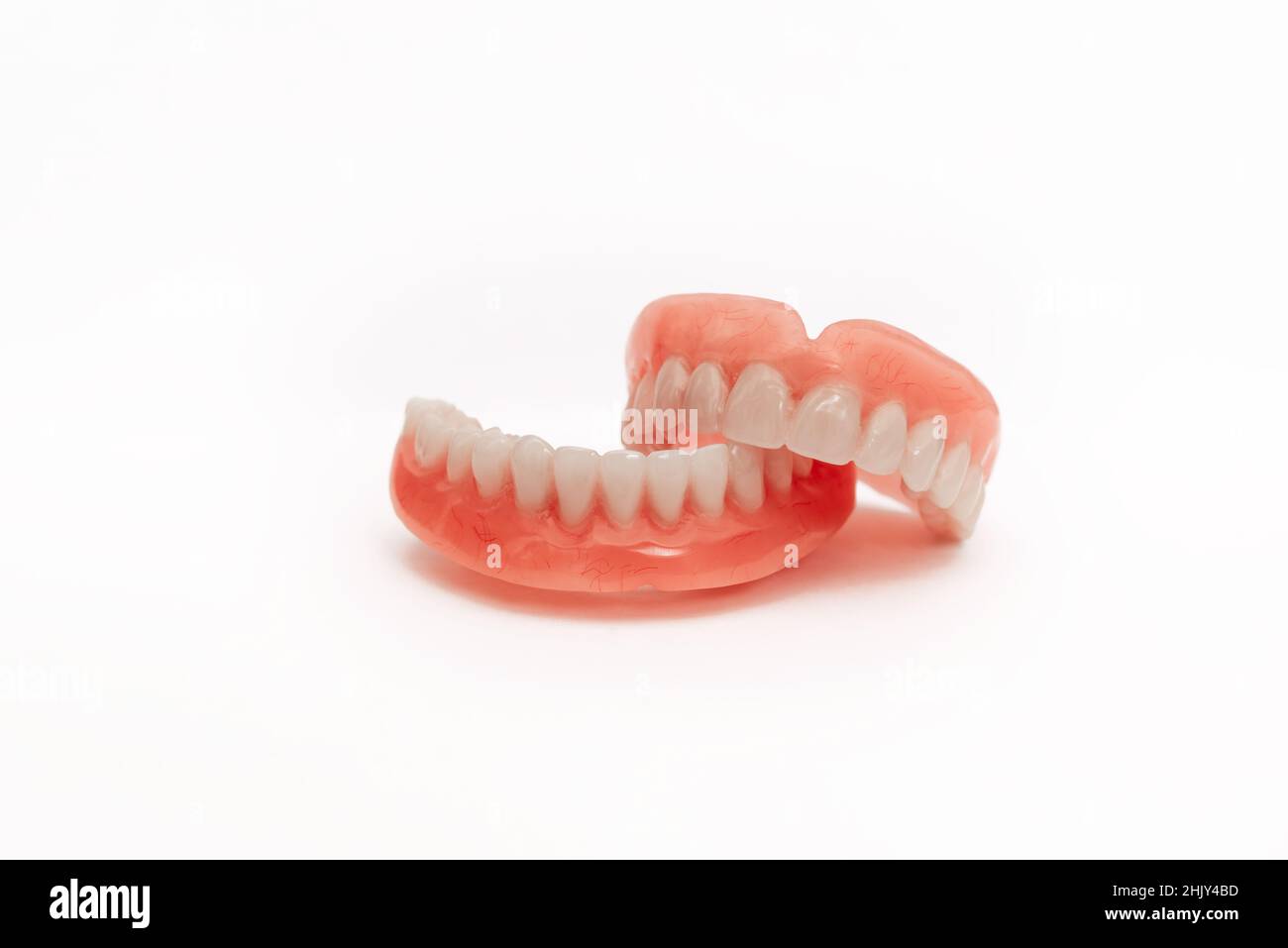Full removable plastic denture of the jaws. Set of dentures on a white