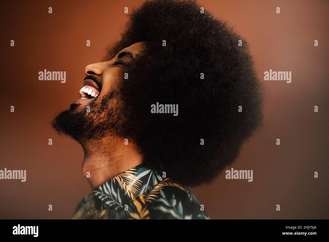 Cheerful young man laughing in studio Stock Photo
