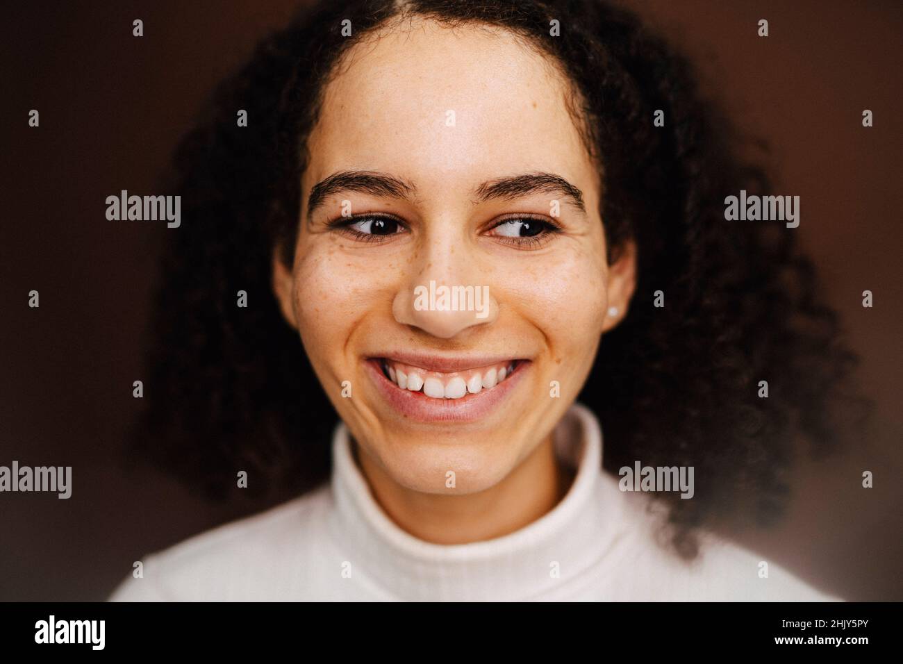 Happy woman wearing turtleneck in studio Stock Photo