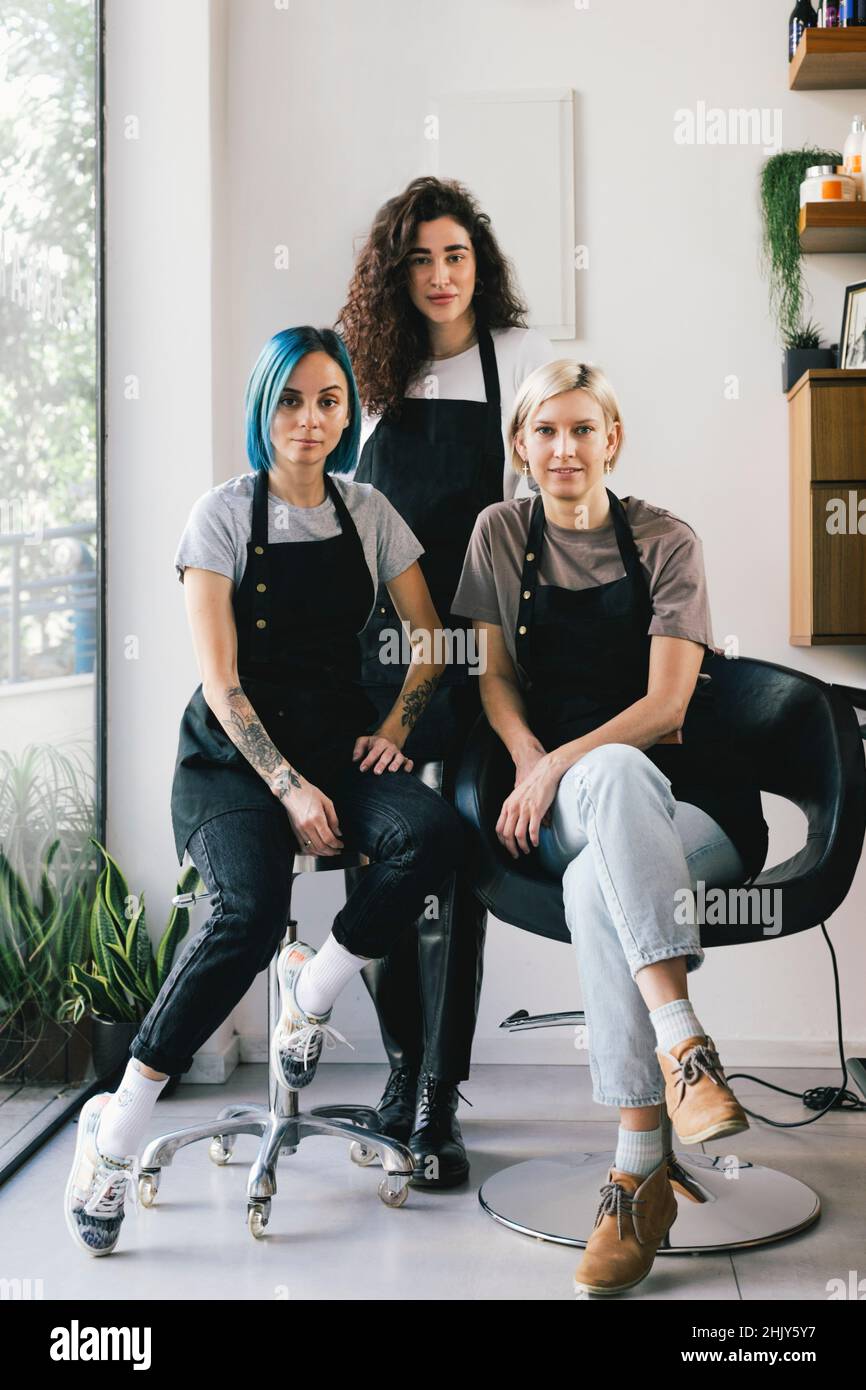 Portrait of confident female hairdressers in salon Stock Photo - Alamy