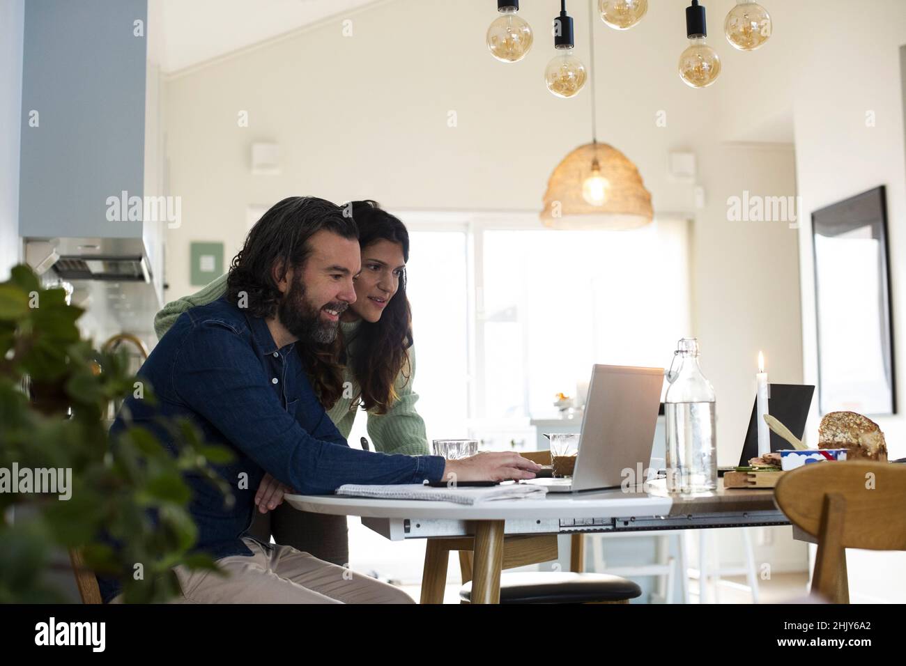 Mature couple using laptop on table at home Stock Photo