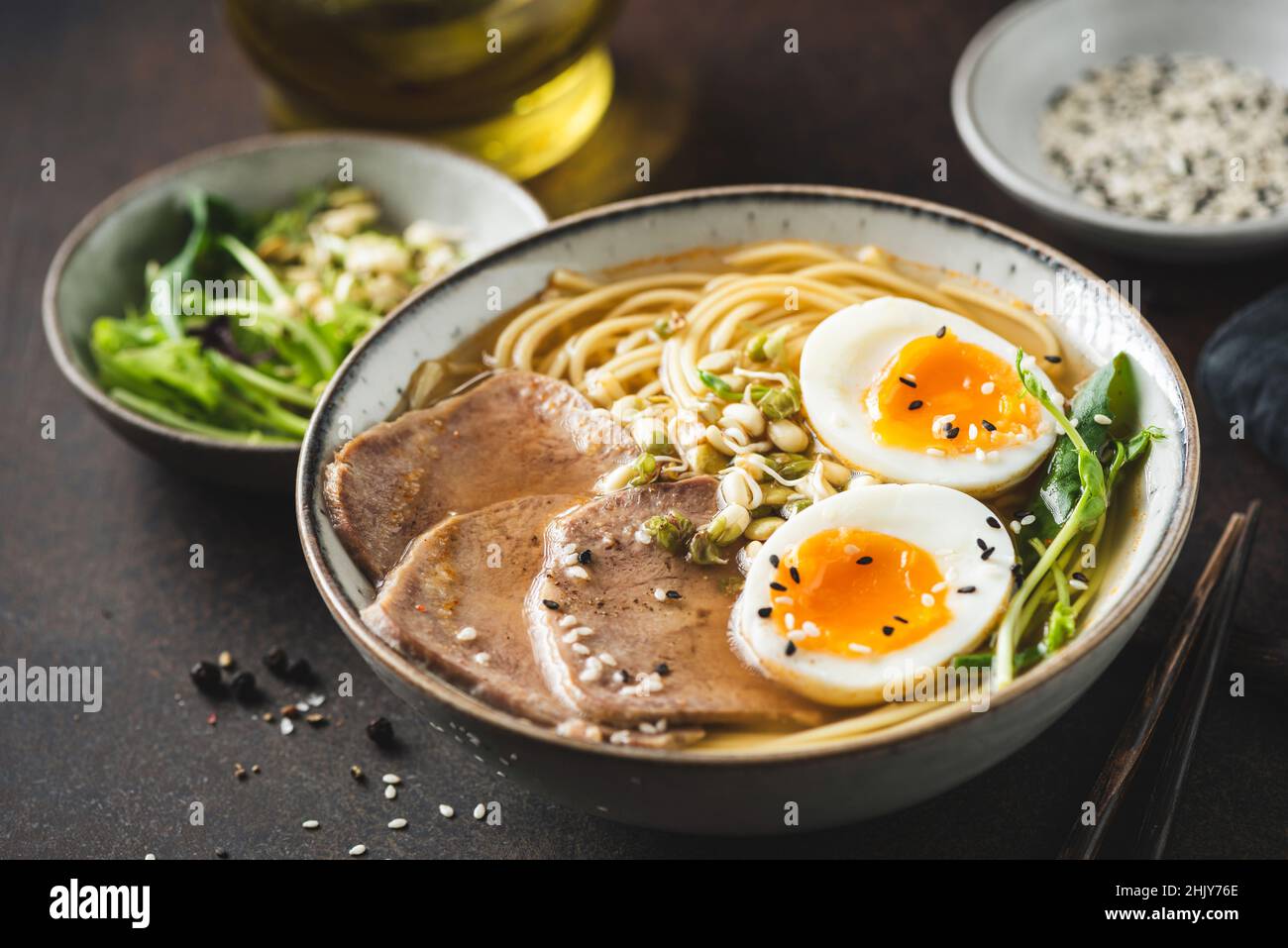 Ramen noodles soup bowl with egg and meat, closeup view Stock Photo