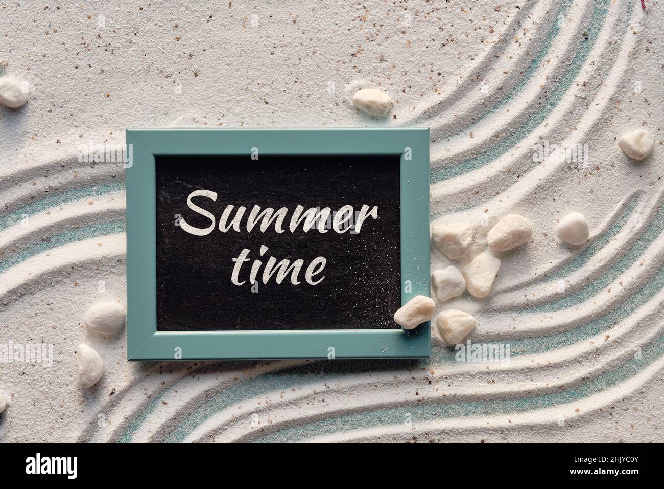 Summer time text on blackboard in mint green frame. Background with white sand with shells, starfish, Stock Photo
