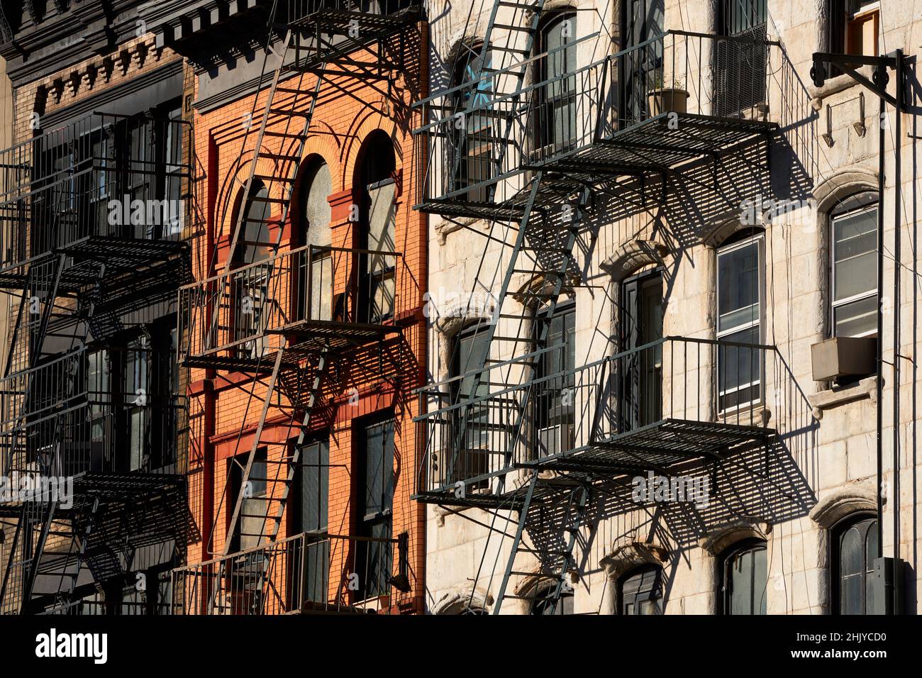 Typical Soho loft building facades with fire escapes and red bricks. Manhattan, New York City Stock Photo