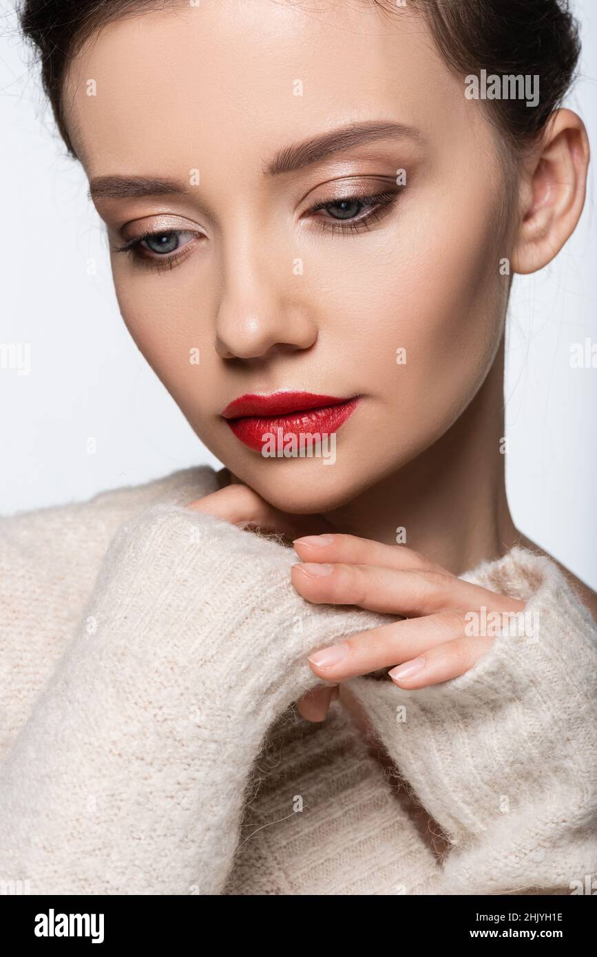 Portrait of pretty model with red lips wearing warm sweater isolated on white Stock Photo