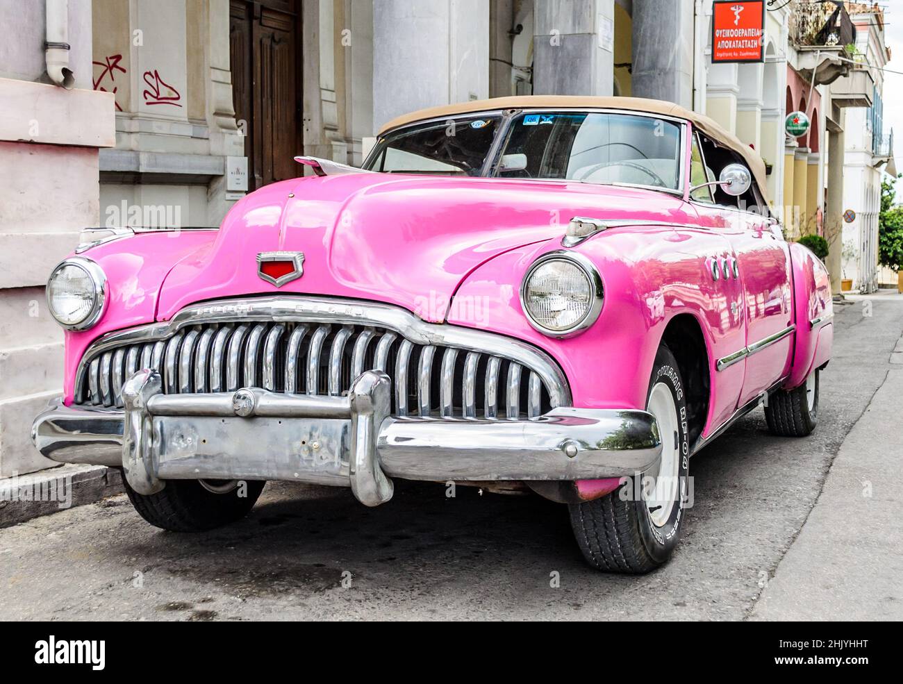 Pink Vintage Antique Car. Rare Buick Super Convertible Sedan Parked Aside the Road in Patras Greece Stock Photo