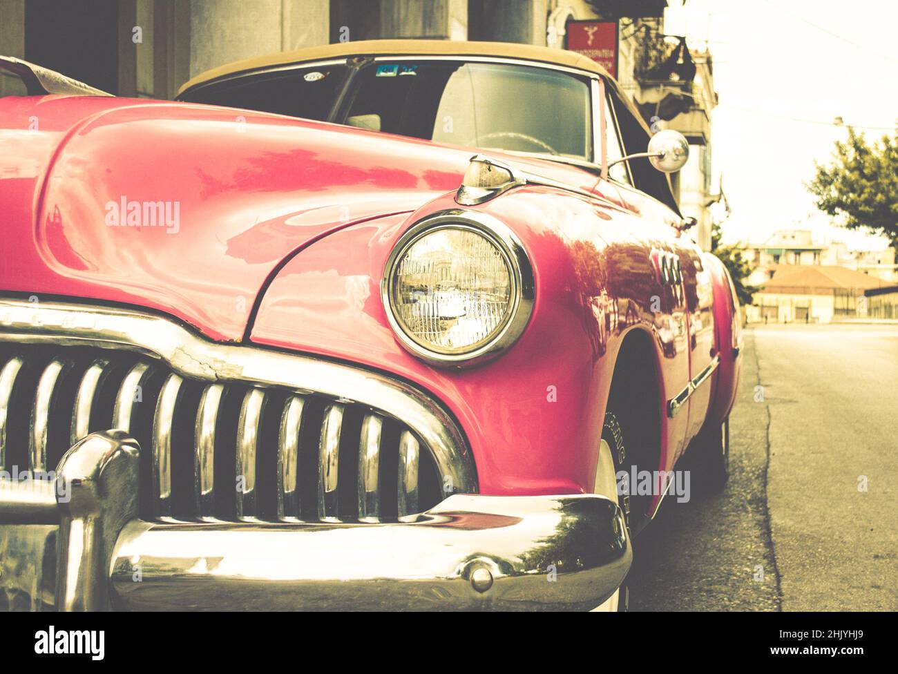 Pink Vintage Antique Car. Buick Super Convertible Sedan Parked Aside the Road in an Old Neighborhood of Patras, Greece. Retro Style Photography Stock Photo