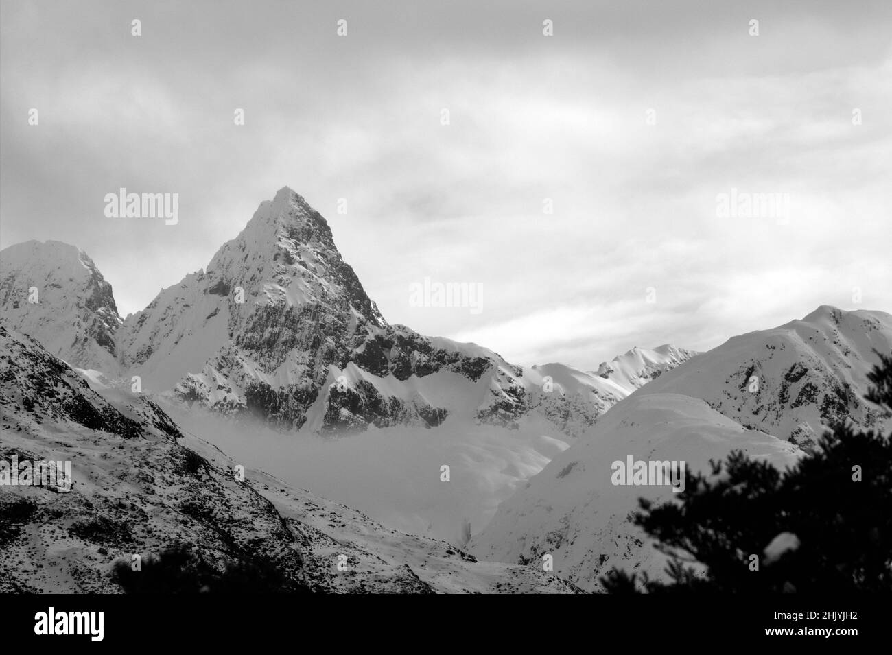An unnamed peak covered in snow and mist, Fiordland National Park, New Zealand Stock Photo