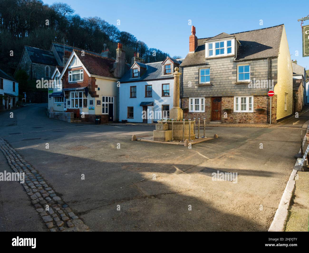 A war memorial stands in The Square, Cawsand, Cornwall, an old fishing village on Plymouth Sound Stock Photo