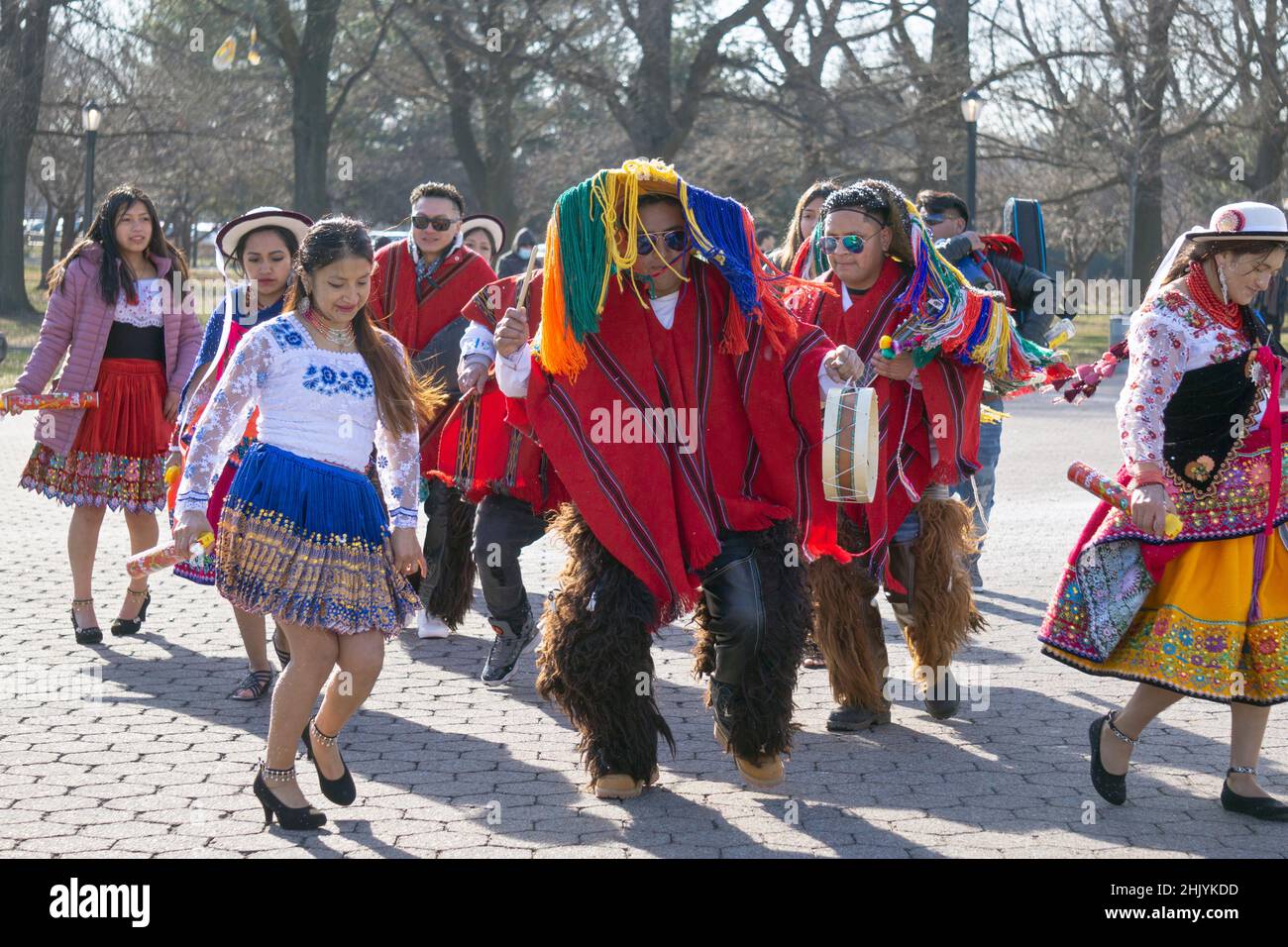 During a video shoot, a group of Ecuadorian dancers & musicians perform alongside the Unisphere in a  park in Queens, New York City. Stock Photo