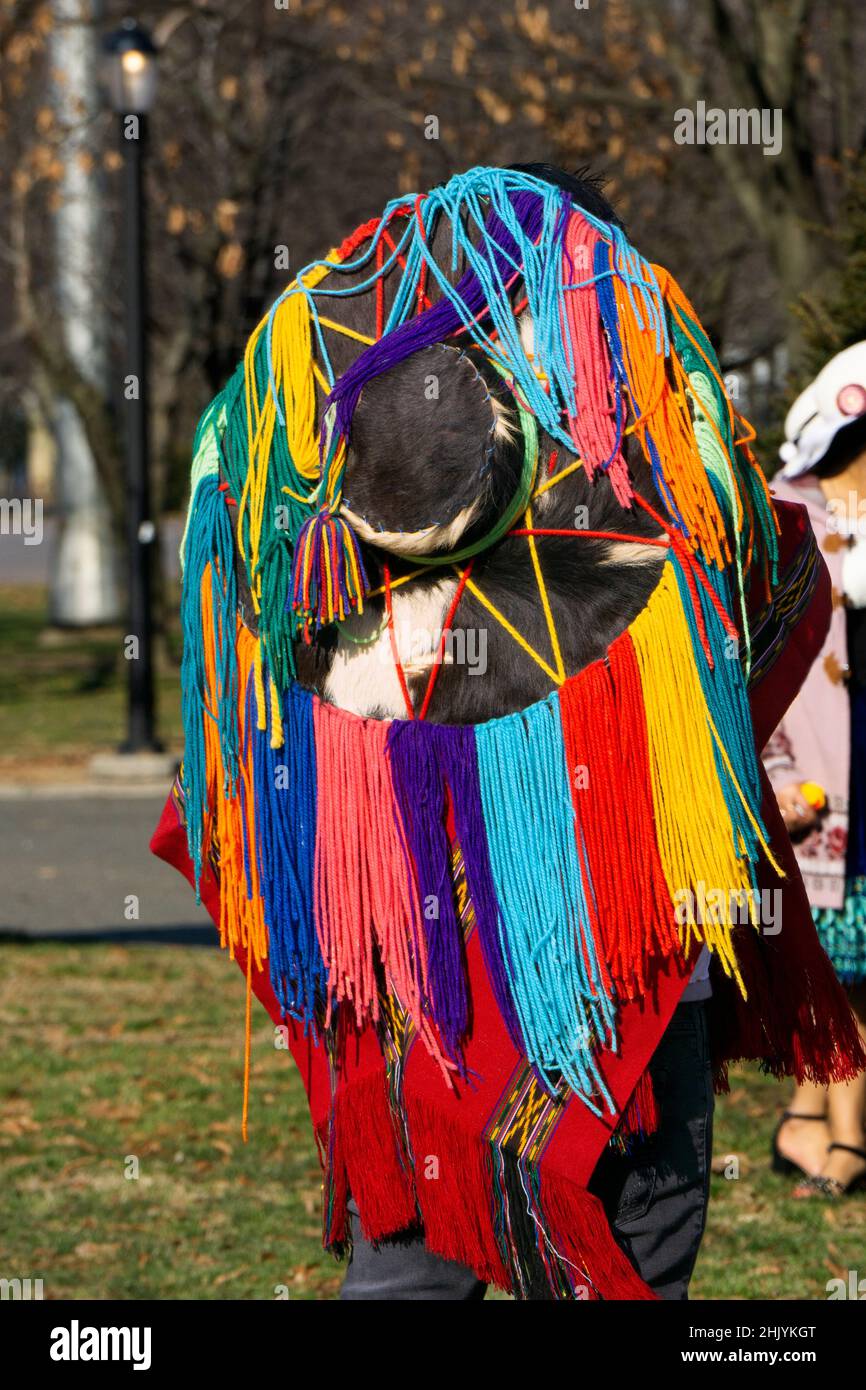 Rear view of the hat worn by an Ecuadorian New Yorker playing the drums & dancing wearing a colorful hat with long strings. In a park in Queens, NYC. Stock Photo