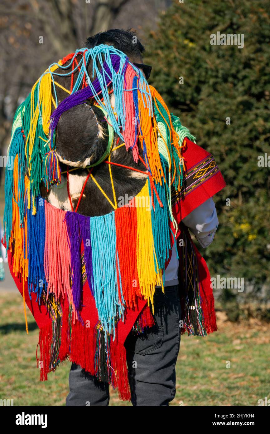 Rear view of the hat worn by an Ecuadorian New Yorker playing the drums & dancing wearing a colorful hat with long strings. In a park in Queens, NYC. Stock Photo