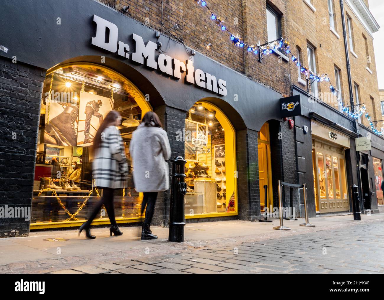 Dr. Martens Shoe Shop, Seven Dials, London. Shoppers walking past the shop front to the fashion brand footwear store near Covent Garden. Stock Photo
