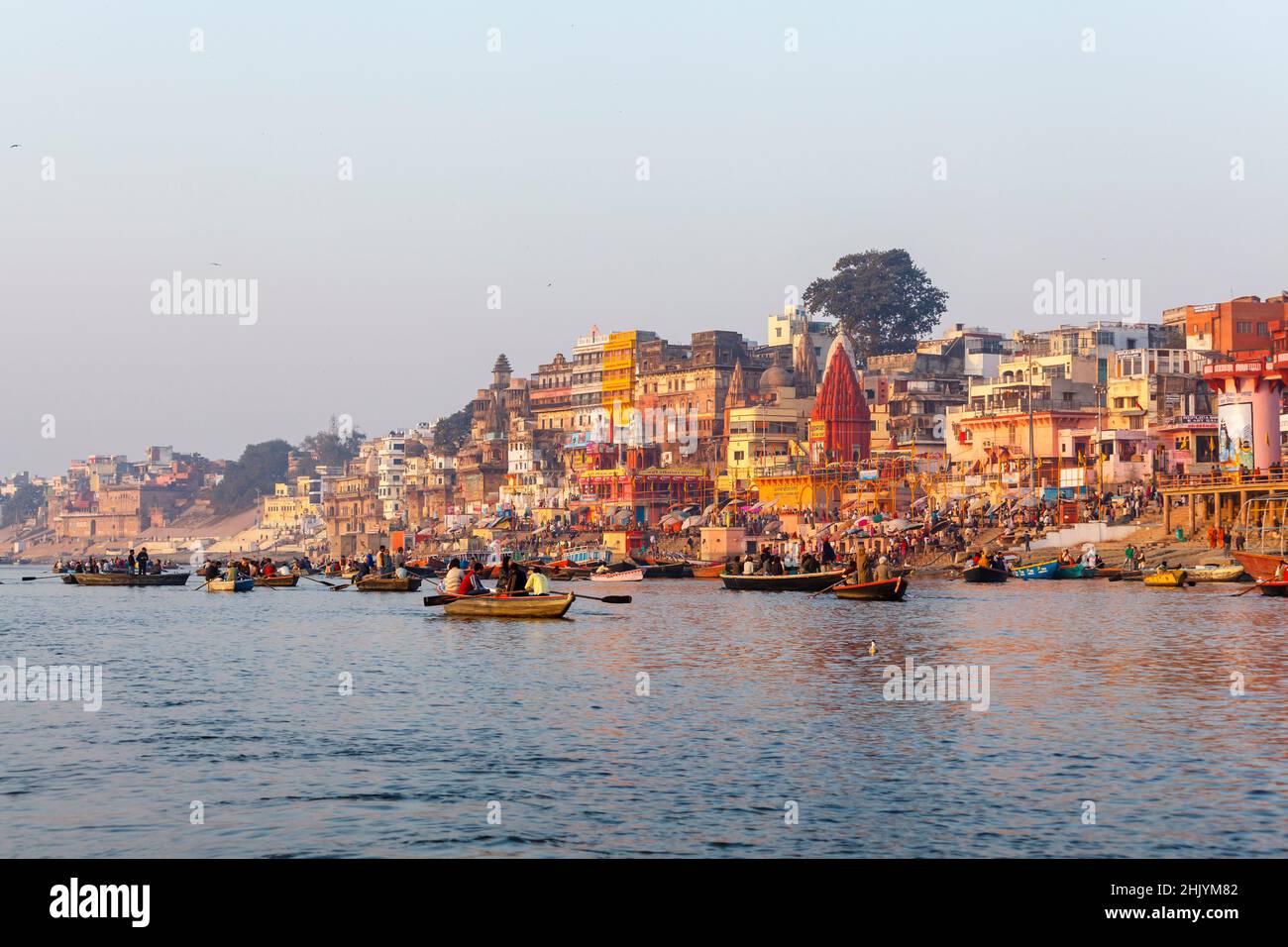 Tourist rowing boats and iconic riverside ghats viewing Prayag Ghat in Varanasi, a city on the River Ganges in Uttar Pradesh, north India Stock Photo