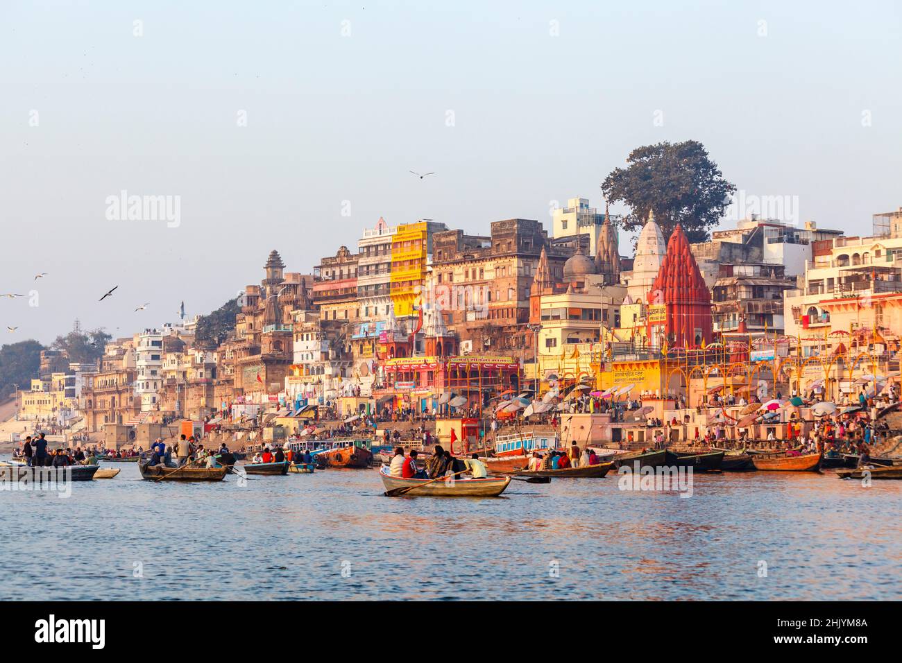 Tourist rowing boats and iconic riverside ghats viewing Prayag Ghat in Varanasi, a city on the River Ganges in Uttar Pradesh, north India Stock Photo