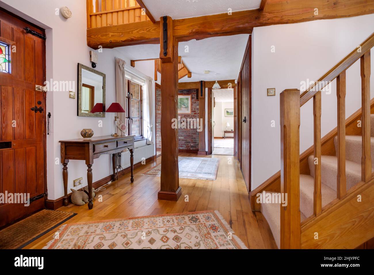 Burrough Green, Suffolk - October 11 2016: Reception hall in traditional looking substancial british home with stairs leading to first floor and brigh Stock Photo