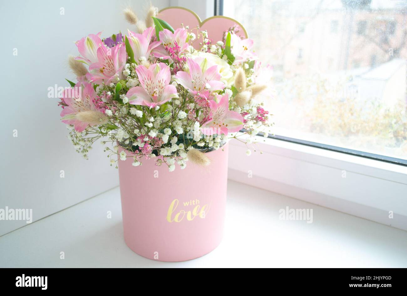 Delicate bouquet of pink lilies, white roses and gypsophila in a love ...