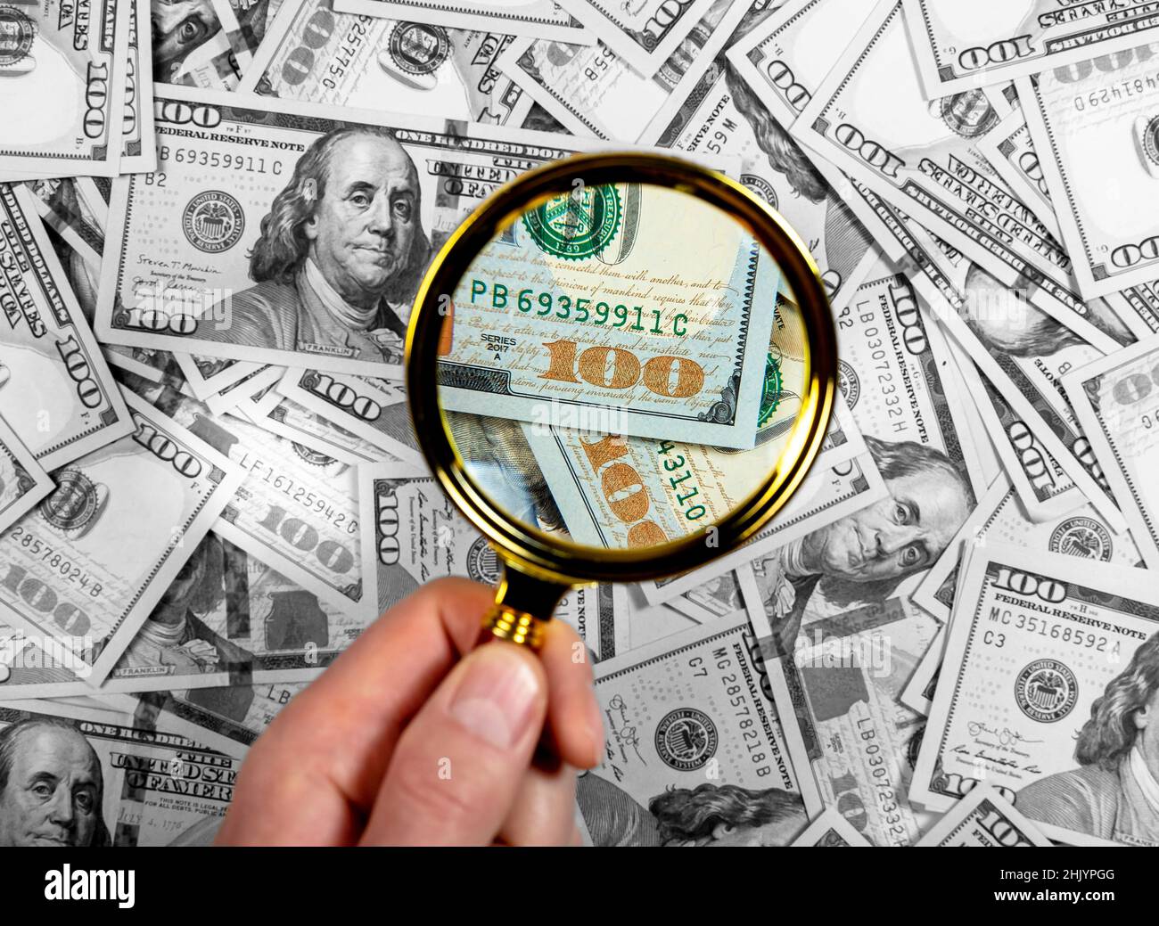 Hundred Dollar Bill And Magnifying Glass Royalty-Free Stock Image