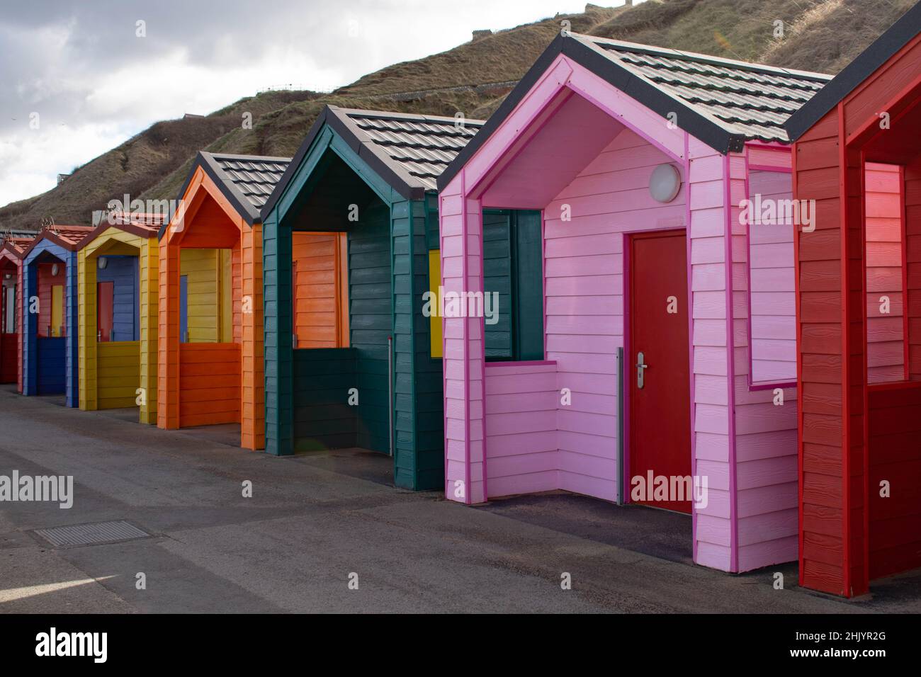 Brightly coloured beach huts Stock Photo Alamy