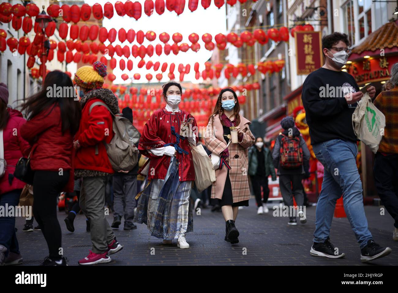 People walk through Chinatown during celebrations on the first day of the Lunar New Year in London, Britain, February 1, 2022. REUTERS/Henry Nicholls Stock Photo