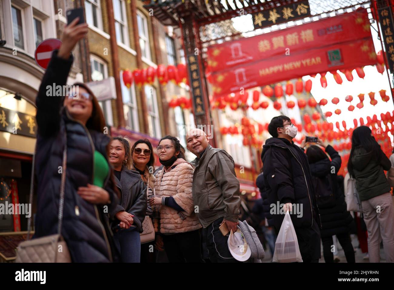 A group take a selfie in Chinatown on the first day of the Lunar New Year in London, Britain, February 1, 2022. REUTERS/Henry Nicholls Stock Photo